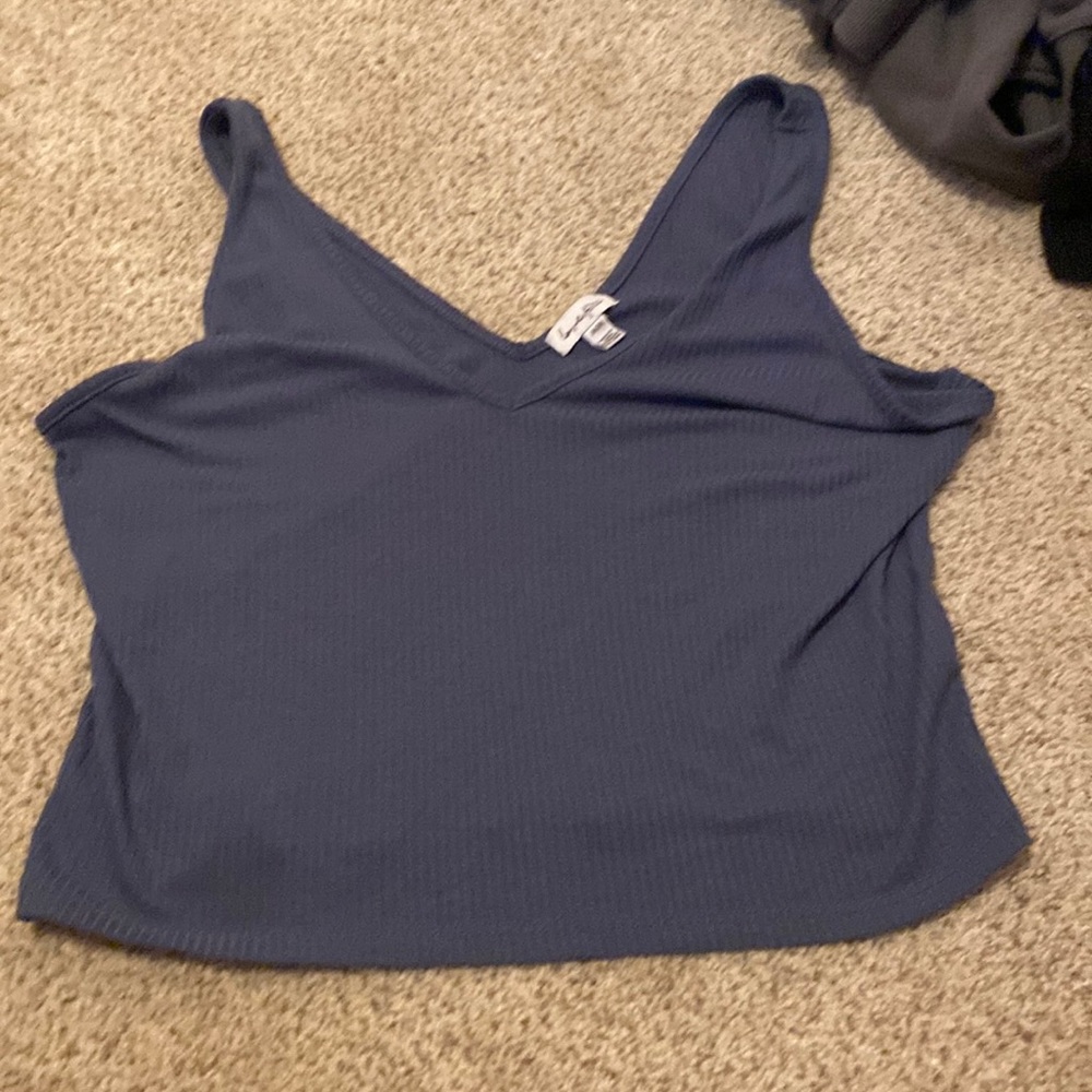 Size medium tank top, color blue with a V cut.
